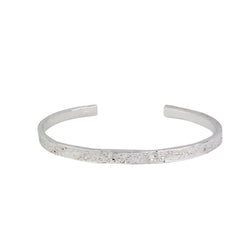 Shiny Silver moon bangle featuring the moon craters that have been individually marked by hand by independent maker Momocreatura