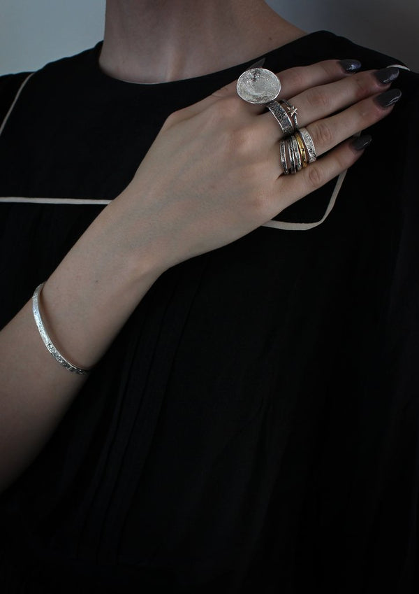 Shiny Silver moon bangle and rings featuring the moon craters that have been individually marked by hand by independent maker Momocreatura