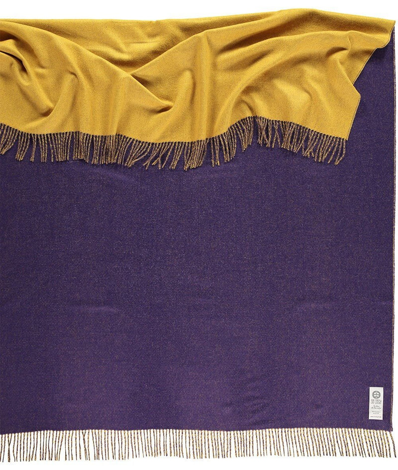 Close up of Woven purple and yellow reversible Baby Alpaca soft blanket designed in the UK by So Cosy