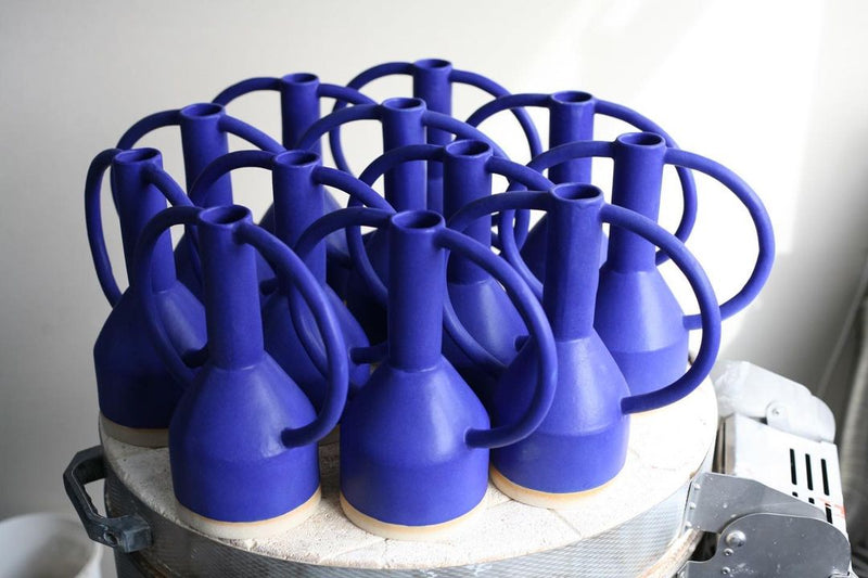 group of blue ceramic vases with 2 big eared handles handmade in London by ceramicist Sophie Alda, available at cuemars.com