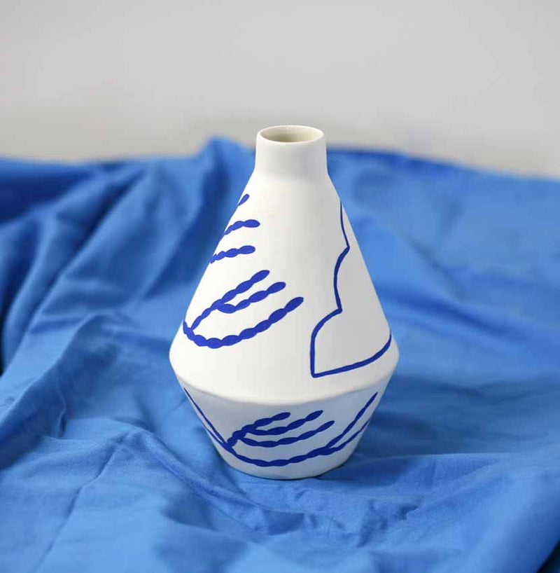 handmade diamond shaped porcelain vase with blue motifs by ceramicist Sophie Alda, available at cuemars.com