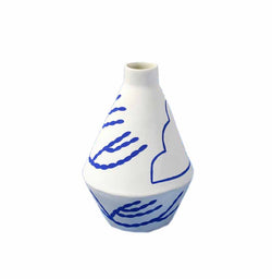 handmade diamond shaped porcelain vase with blue motifs by ceramicist Sophie Alda, available at cuemars.com