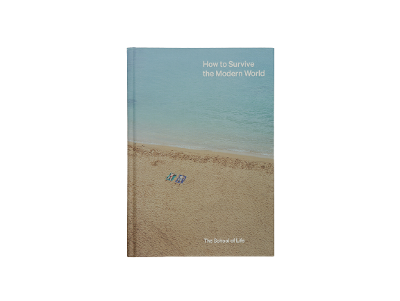 Book cover of a sandy beach with two people sunbathing and the title How To Survive the Modern World by The School of Life. Available at cuemars.com