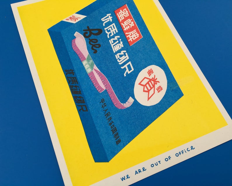 Details of vibrant risograph print of a blue box of colourful cloth tape measures on a bright yellow background. Designed and printed by Dutch company We are out of office.