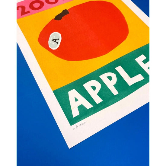200m apples risograph print that features a red apple on a yellow, pink and green background. By We are out of office, available now at www.cuemars.com